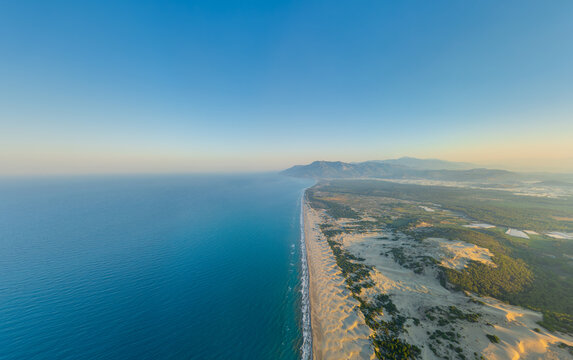 Gelemis, Turkey. Endless Patara Beach at morning, mediterranean sea meeting long sandy shore in summer, vast coastal panorama from above. Aerial view