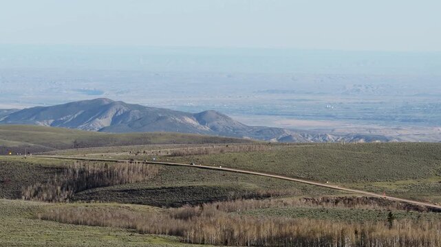 Aerial of Ashley National Forest and US highway 191 with high desert background in spring in Utah