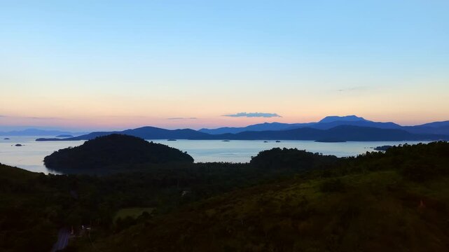 Sunset Sky Over Distant Mountains and Sea
