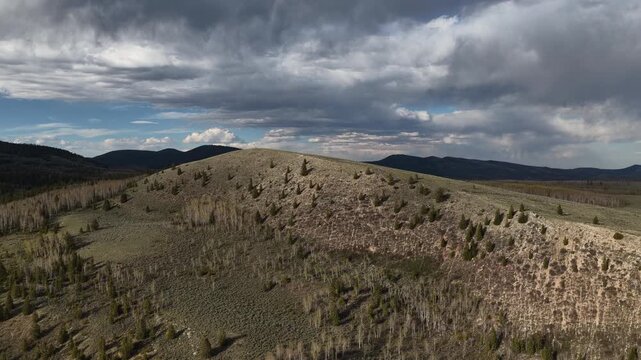 Aerial of Ashley National Forest in northeast Utah Uinta Mountains with stormy sky in spring time