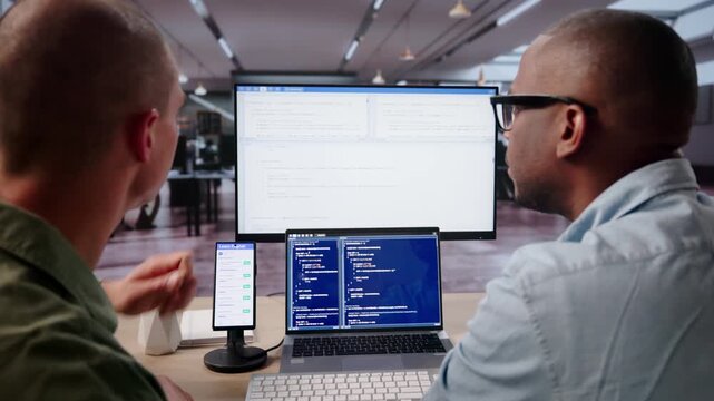 Software Engineer Debugging Mobile Phone App On Desktop