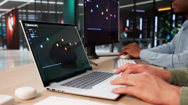 Cybersecurity Analysts Discuss Threat Detection Using Laptop