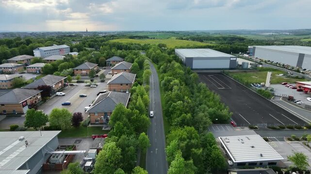 Aerial drone tracking shot following white car through Silkwood Park Wakefield