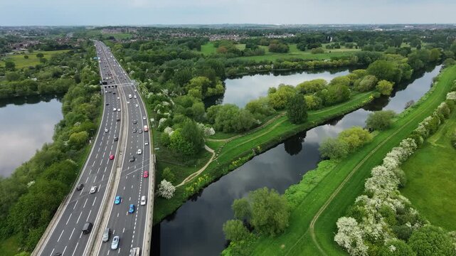 Drone aerial shot moving away from M1 motorway revealing lakes in Wakefield