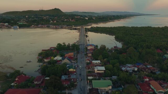 Aerial sunset overview of bridge and coastline in Dauis Bohol Philippines
