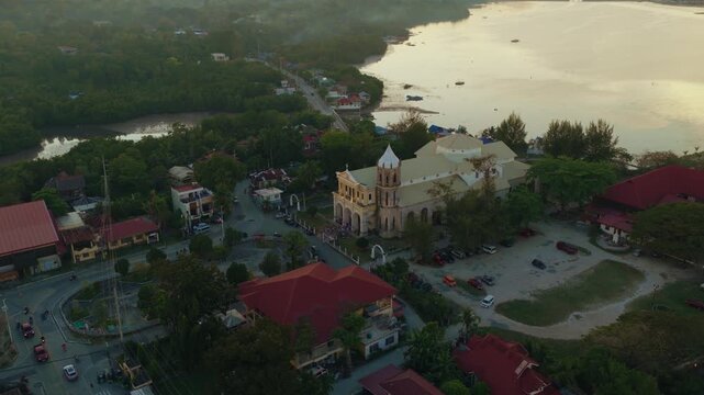 Aerial overview of Dauis Church beside coastline in Bohol Philippines