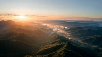 Fototapeta premium Sunrise over mountain range with warm golden light, cinematic drone style wide shot, realistic 