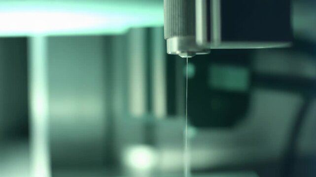 Advanced 3d bioprinter machine precisely depositing biotechnology material into a petri dish, developing engineered cells and organic structures for modern medical science experiments and innovation