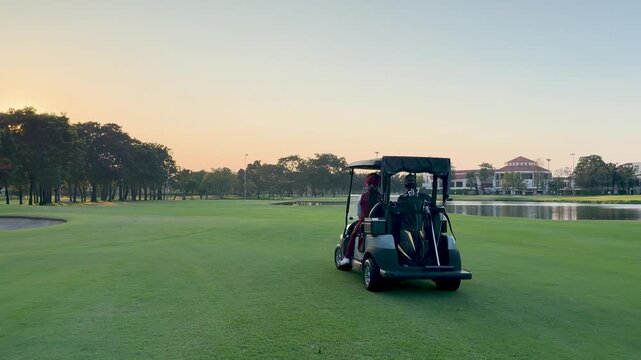 Asian Woman in Red Outfit Driving Golf Cart at Sunset in Bangkok