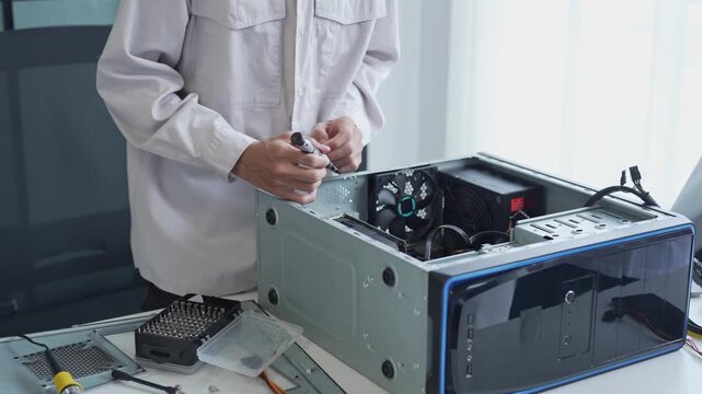 Asian man using screwdriver maintenance computer
