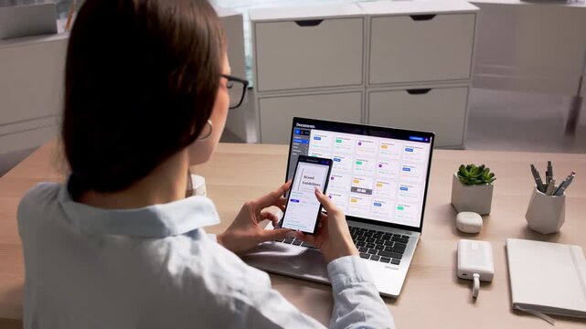 Young Woman Using Document Management Software On Laptop