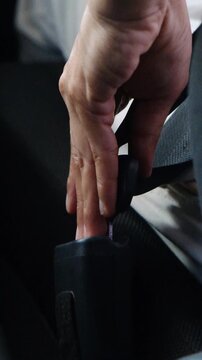 The process of clipping the seat belt in the car close up