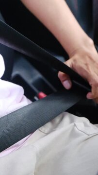 The process of clipping the seat belt in the car close up