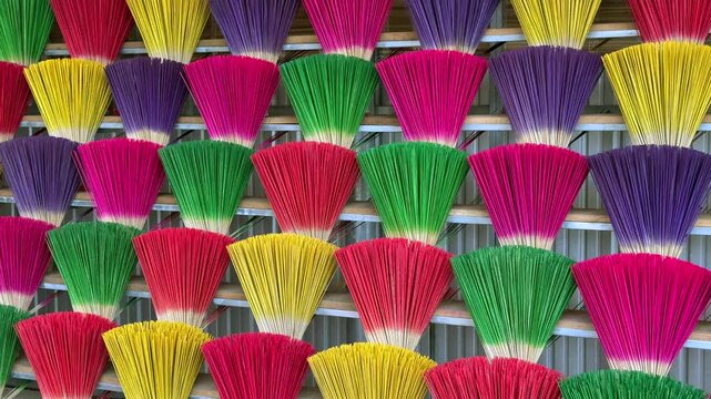 Colorful incense sticks arranged in rows at local Vietnamese market, reflecting traditional craftsmanship, daily life, and cultural rituals in Vietnam.