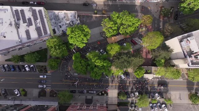 May Day Protest Marchers On City Street Near City Hall Of Tacoma In Washington, USA. aerial topdown shot