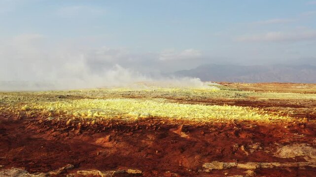 Aerial view of the Danakil Desert featuring sulfur deposits and steam rising from the geothermal fields in Dalol, Afar, Ethiopia.