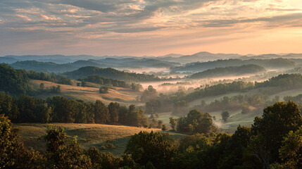 Naklejka premium Scenic view of rolling hills and lush forests at sunrise with mist and vibrant sky