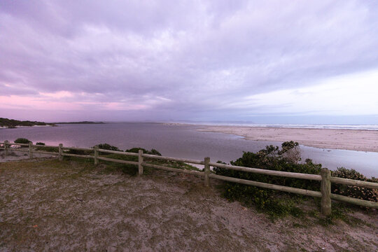 muted sunset light over Grotto lagoon and sand dunes, Hermanus, South Africa