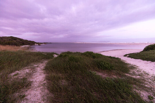 muted sunset light over Grotto lagoon and sand dunes, Hermanus, South Africa