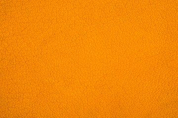 Fototapeta premium Orange fuzzy fabric texture close up