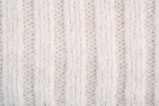 Cream knit fabric with vertical ribbing texture