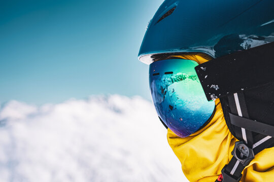 Close up of snowboarder helmet and mirrored ski goggles