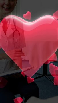 Vertical video: Doctor noting patient input starting heart AR breaking into hearts revealing clinic