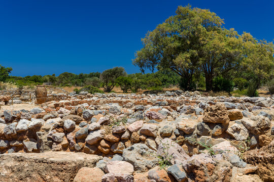 Archaeological site showing stone walls and pithos jar at Malia, Crete