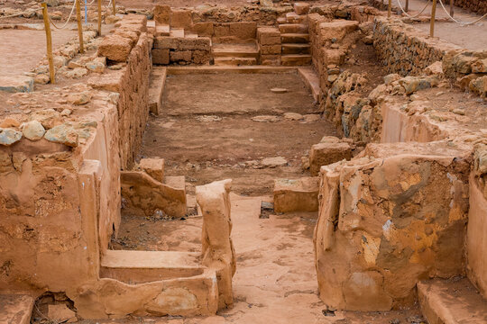 Excavated stone walls and chambers at the Minoan Palace of Malia on Crete, Greece