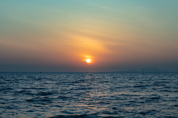 Fototapeta premium Morning sunrise views from a speeding longtain boat over the Andaman Sea, offshore of Krabi, in southern Thailand. 