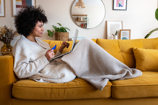Woman making online purchase with credit card at home