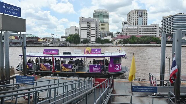 4K Passenger ferry boat arriving at Tha Phra Chan pier