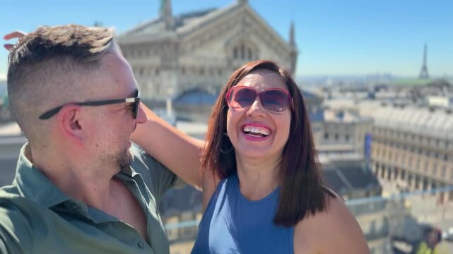 Happy tourist couple taking a selfie on a rooftop, enjoying their romantic vacation in Paris with a beautiful view of the city skyline, including the iconic Eiffel Tower and other landmarks