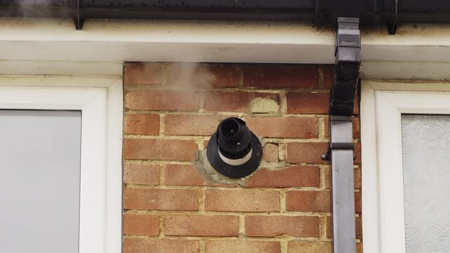 Combination Boiler heating flue vent condensation 4X slow motion stock footage