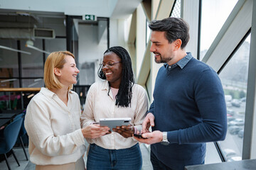Diverse business team collaborating using digital tablet in office © Jelena