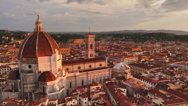 Orbiting drone shot of Florence old town with the setting sun, Italy, Florence Renaissance cahedral Santa Maria del Fiore at sunset aerial video, travel in Tuscany, Italy