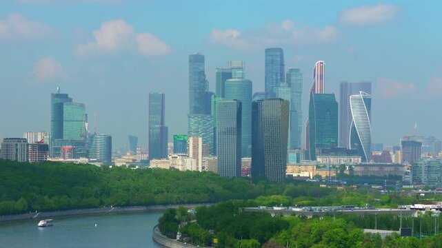 Video captures a striking panorama of a modern city skyline integrated with lush greenery, showcasing the balance between urban development and nature