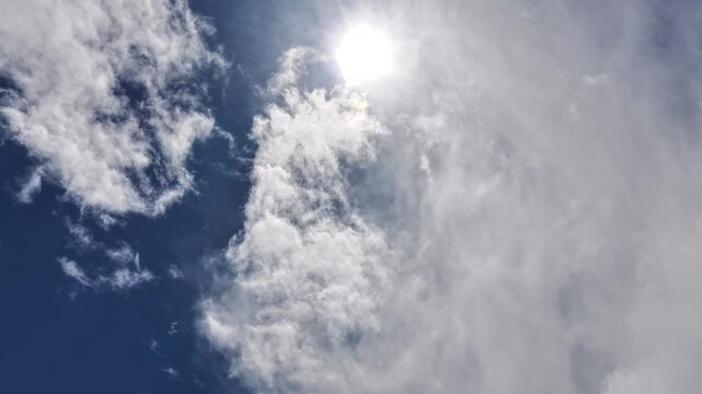 4K drone timelapse captures dark stormfront clouds moving and covering the sun. Cinematic atmospheric motion reveals shifting heavy weather and high-contrast light over a vast southwestern vista.