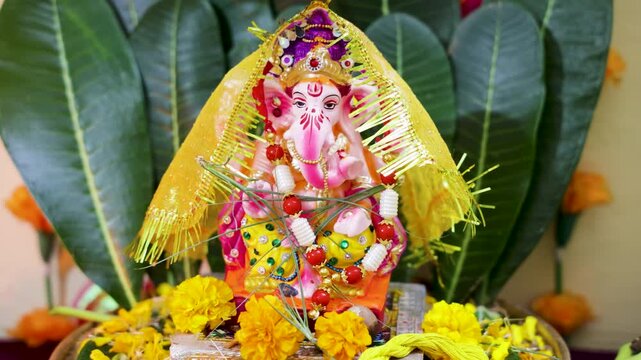 beautiful ganesha murti with floral decoration and sacred hindu worship setup