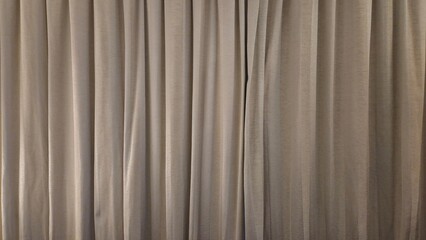 Obraz premium Beige fabric curtain texture with vertical folds and drapes