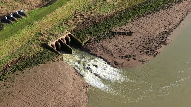Aerial view of pumping station discharging overflow water into the River Haven, Lincolnshire, UK.
