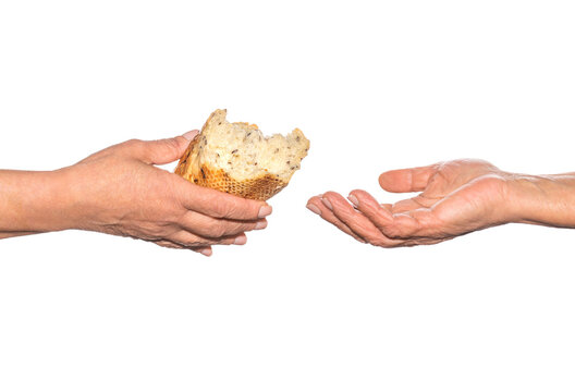 Pieces of bread. Helping the homeless. Elder woman hand give a loaf of bread to hands of a beggar. Poverty and world hunger concept