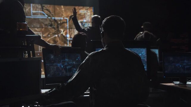 man army officer coordinating special operations mission in command post, monitoring surveillance satellite footage on big screen in military power base. soldier on duty. launch nuclear Rocket bomb