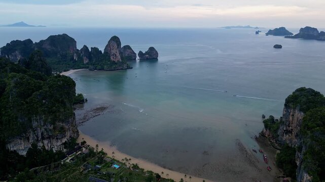 Krabi, Thailand : Aerial drone footage of Tonsai and Railey west beach in Andaman coastline, Krabi of Thailand surrounded by limestone cliff. Taken with orbit and downward motion