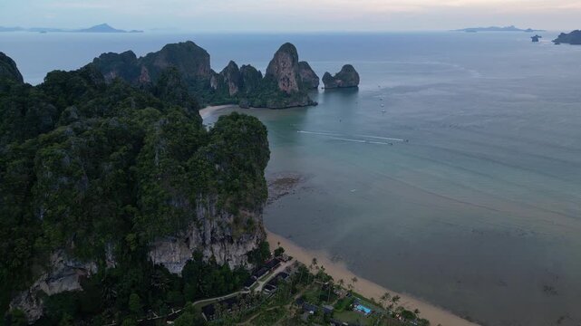 Krabi, Thailand : Aerial drone footage of Tonsai and Railey west beach in Andaman coastline, Krabi of Thailand surrounded by limestone cliff. Taken with orbit and downward motion