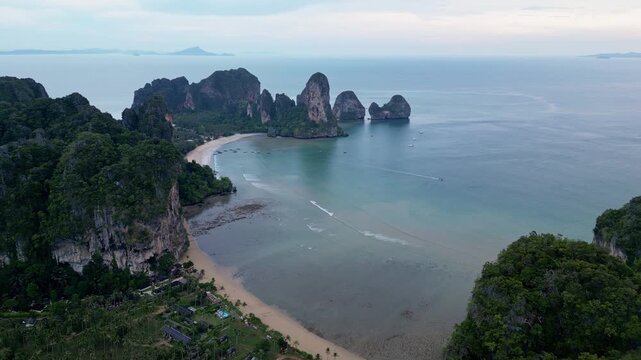 Krabi, Thailand : Aerial drone footage of Tonsai and Railey west beach in Andaman coastline, Krabi of Thailand surrounded by limestone cliff. Taken with orbit and downward motion