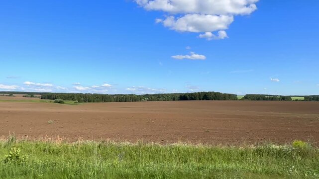 Moscow, Russia, 10.05.2025 moscow, russia, 10.05.2024 A large field with a blue sky and a few clouds. The sky is clear and bright, and the field is mostly green