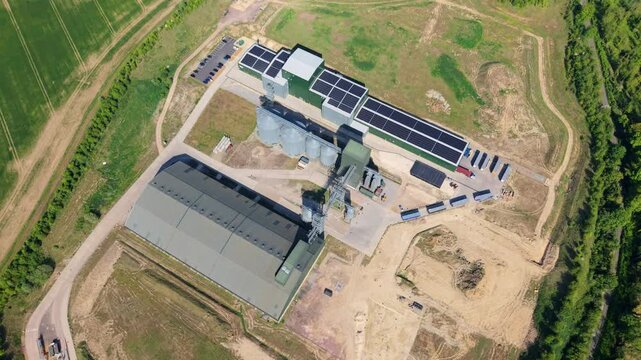 Aerial view of Navara Oat Milling facility with industrial silos and solar panels on rooftops surrounded by green fields in Kettering, England, United Kingdom.