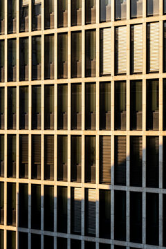 A Frankfurt office tower becomes a vertical grid of windows as sunlight and shadow cross the facade, giving architecture a measured rhythm