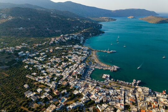 Drone shot overlooking the scenic coastline and harbor of Elounda, Crete